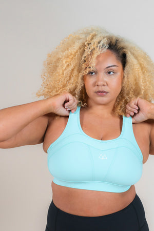 Woman standing wearing MAAREE Empower Sports Bra in Spearmint Green colour